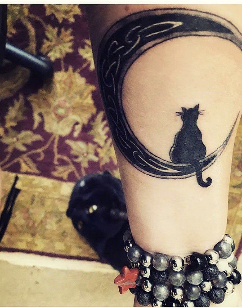Crescent moon and black cat tattoo done on the ankle,
